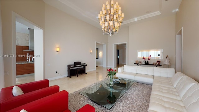 living room with a high ceiling, sink, and a notable chandelier