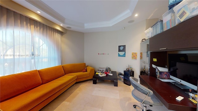 office area with ornamental molding and a tray ceiling