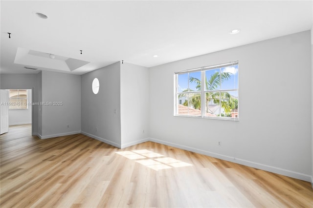 unfurnished room with light wood-type flooring