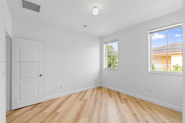 empty room with light hardwood / wood-style flooring