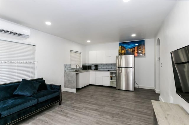 kitchen featuring white cabinets, stainless steel appliances, modern cabinets, arched walkways, and a sink