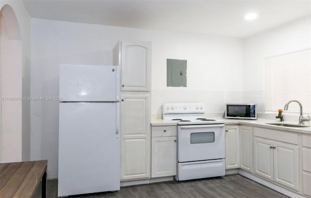 kitchen with white cabinetry, dark wood-type flooring, electric panel, white appliances, and sink