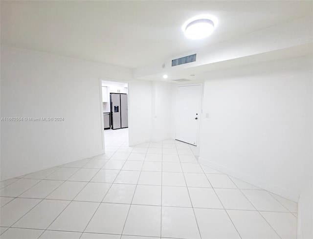 unfurnished room featuring light tile patterned floors