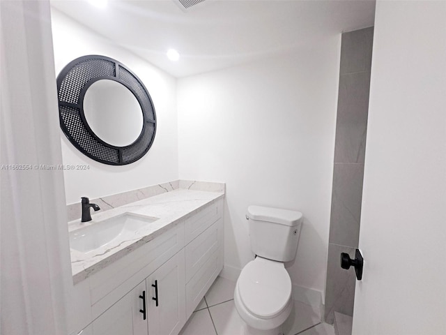 bathroom with vanity, tile patterned flooring, and toilet