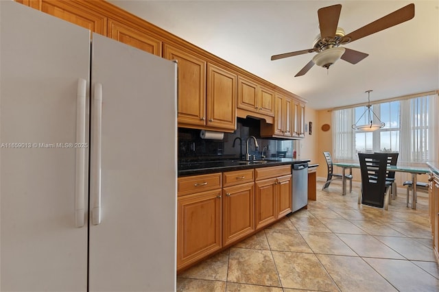 kitchen with white fridge, ceiling fan, decorative backsplash, dishwasher, and sink