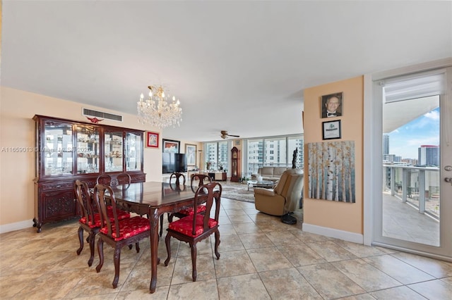 tiled dining area featuring ceiling fan with notable chandelier