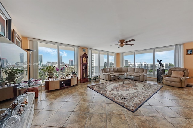 living room featuring ceiling fan, light tile patterned floors, and a wall of windows