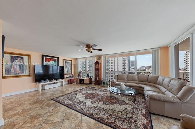 living room featuring ceiling fan and expansive windows