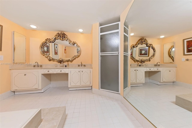 bathroom with tile patterned floors, vanity, and walk in shower