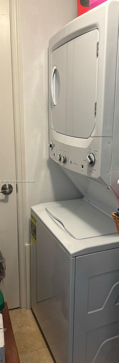 laundry area with stacked washer and dryer