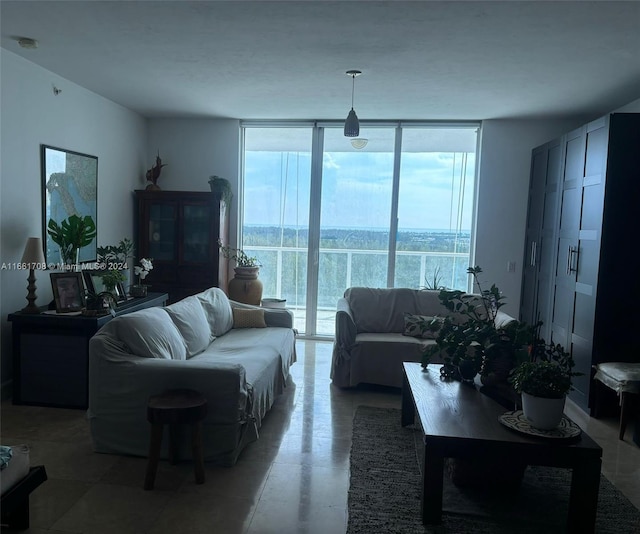 living room with a water view and a wall of windows