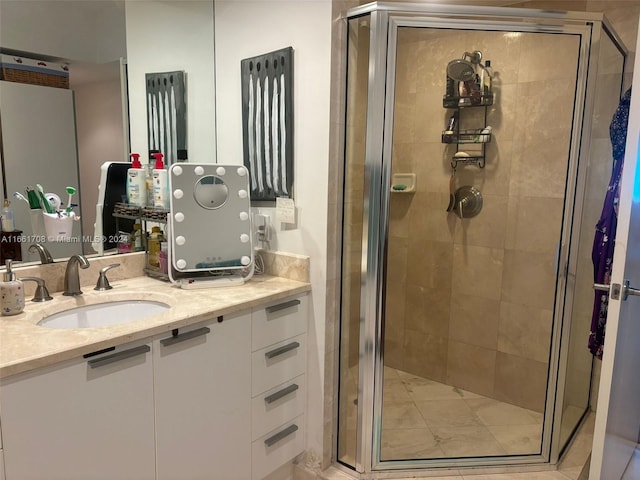 bathroom with vanity and a shower with door