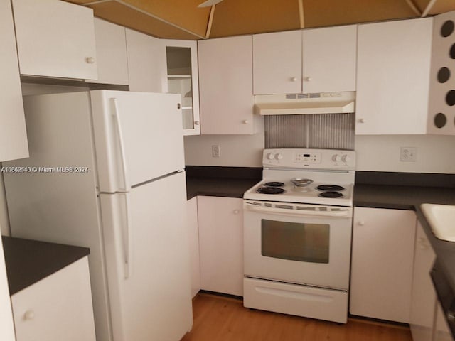 kitchen featuring white appliances, white cabinetry, and light hardwood / wood-style flooring