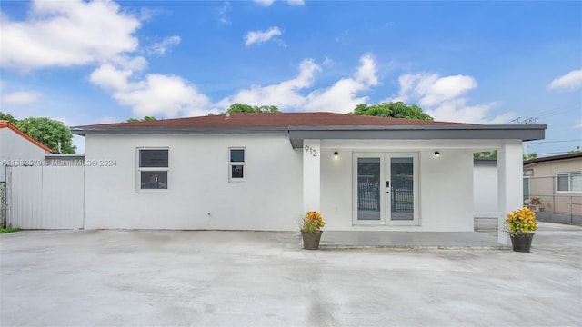 rear view of property featuring french doors and a patio area