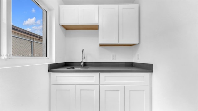 kitchen with white cabinetry and sink