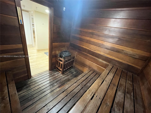 view of sauna featuring wood-type flooring and wood walls