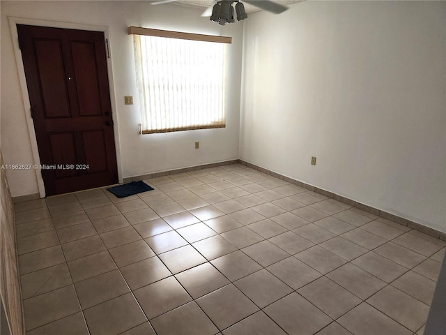 unfurnished room featuring light tile patterned flooring and ceiling fan