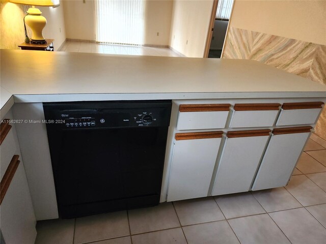 kitchen featuring black dishwasher, white cabinetry, and light tile patterned floors