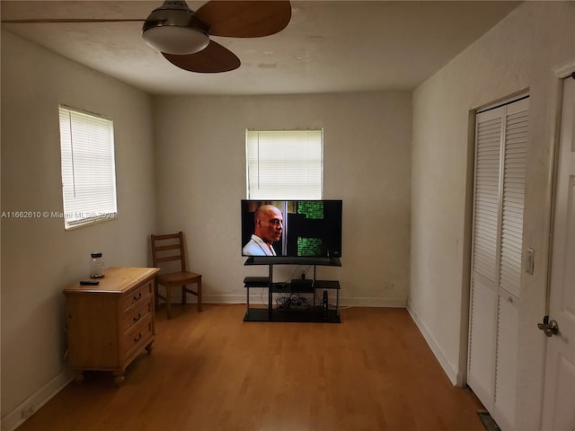 living area with ceiling fan and hardwood / wood-style flooring