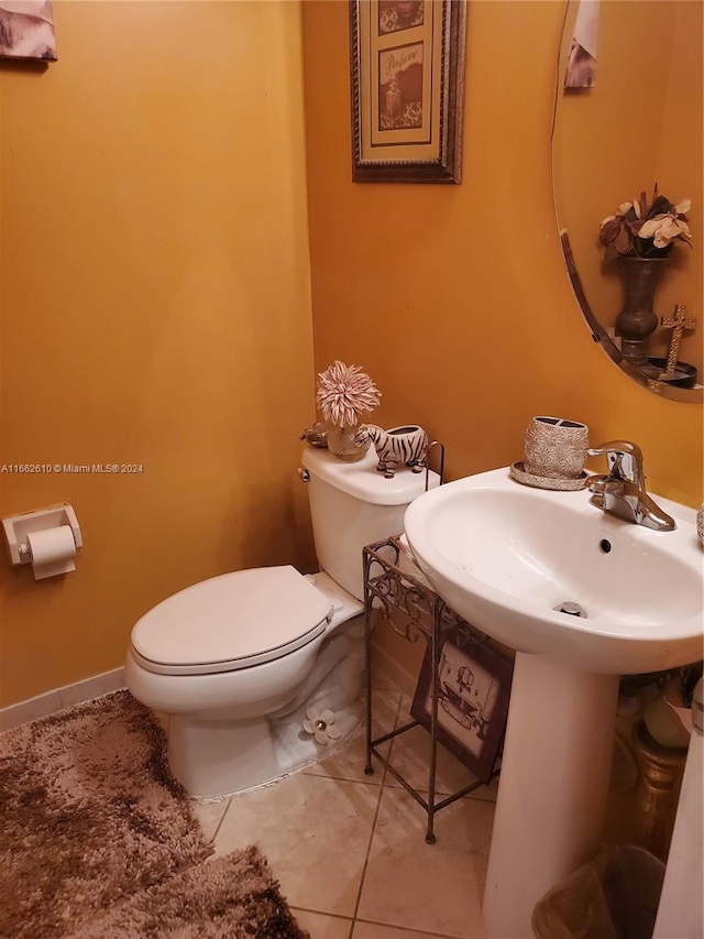 bathroom with toilet and tile patterned floors