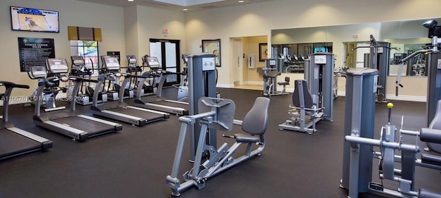 exercise room with a high ceiling