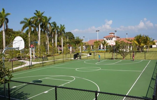 view of jungle gym featuring a community pool and a lawn