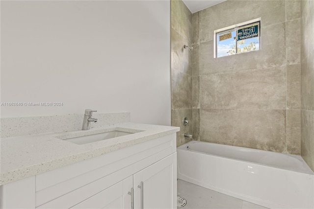 bathroom with vanity and tiled shower / bath