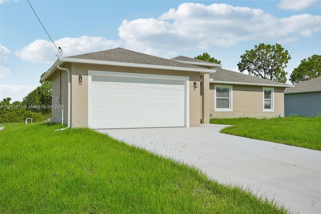 ranch-style house featuring a garage and a front lawn