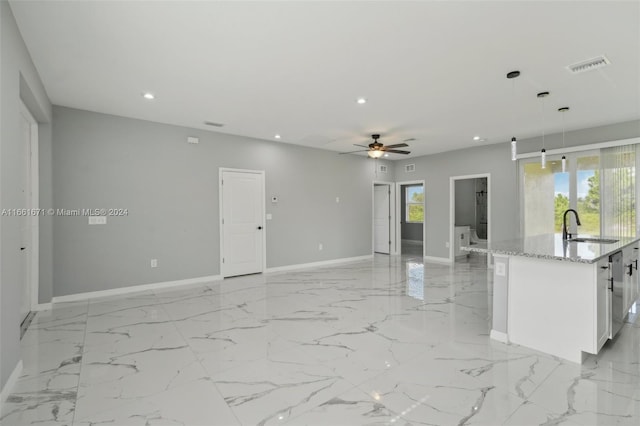 empty room with ceiling fan and sink