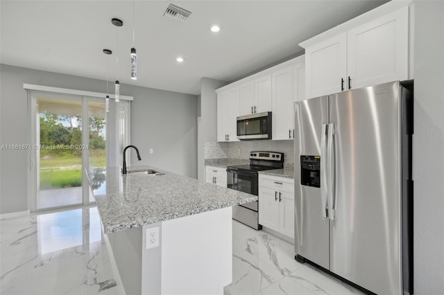 kitchen featuring a kitchen island with sink, sink, white cabinetry, hanging light fixtures, and appliances with stainless steel finishes