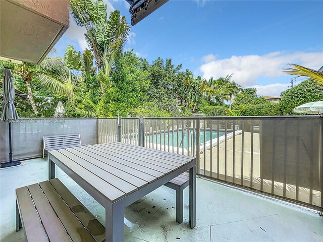 exterior space with a fenced in pool and a patio