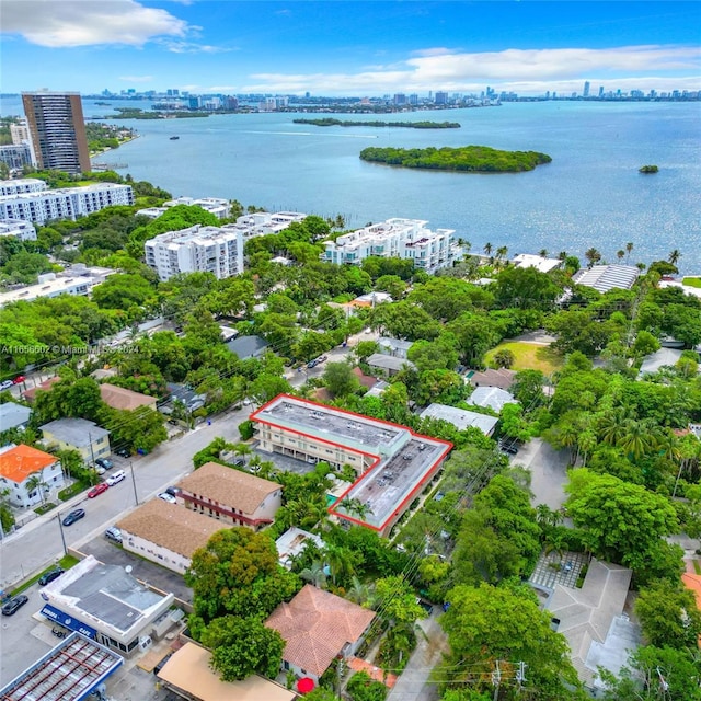 birds eye view of property with a water view and a view of city