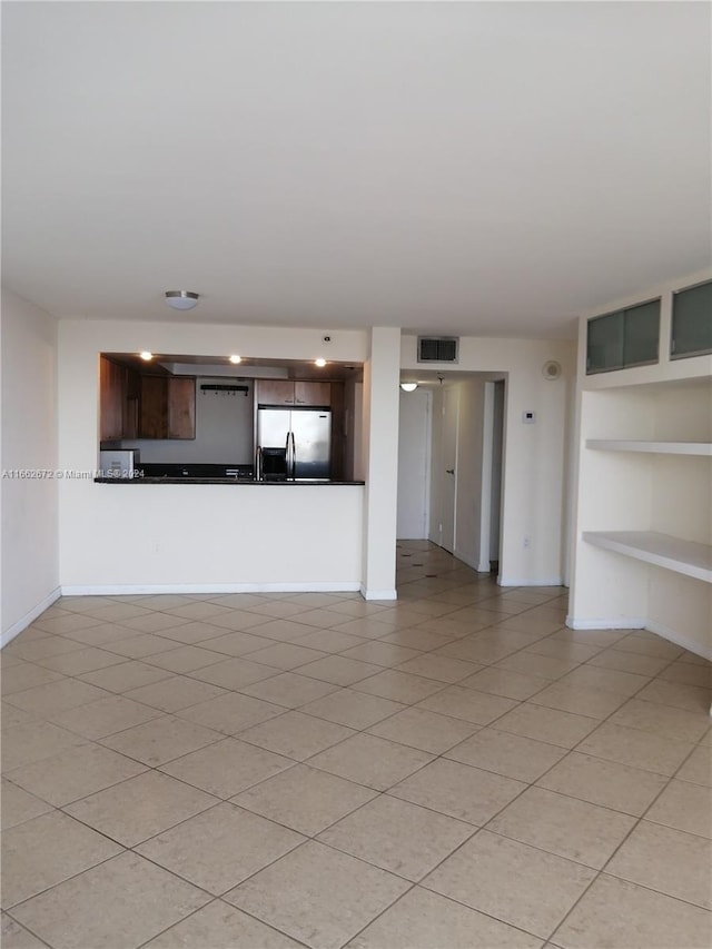 unfurnished living room with light tile patterned floors