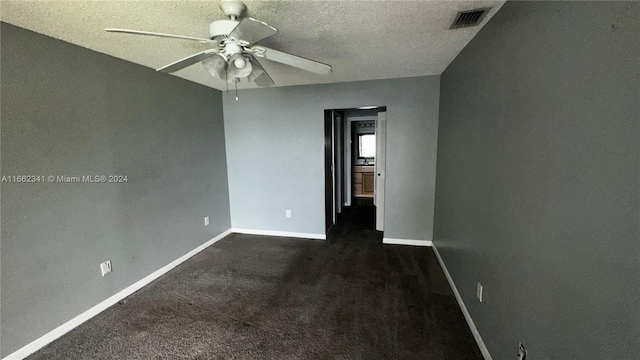 carpeted empty room with a textured ceiling and ceiling fan