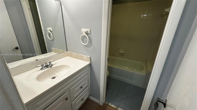 full bathroom featuring vanity, tiled shower / bath combo, toilet, and tile patterned flooring