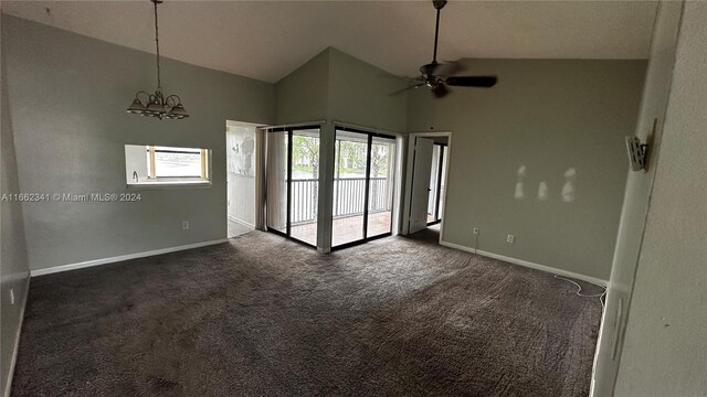 carpeted empty room featuring high vaulted ceiling, a wealth of natural light, and ceiling fan with notable chandelier