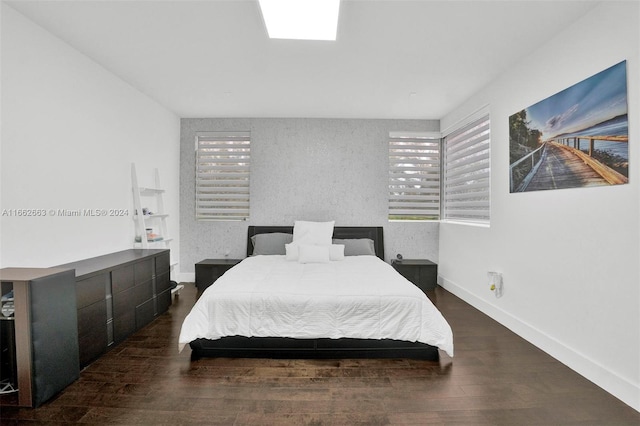 bedroom with dark hardwood / wood-style flooring