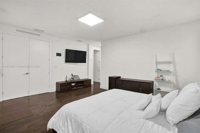 bedroom featuring a closet and dark hardwood / wood-style flooring