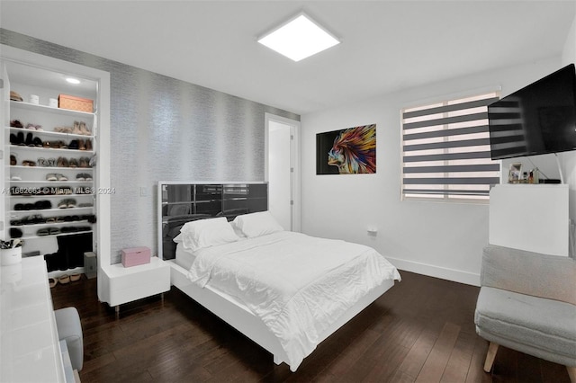 bedroom with dark hardwood / wood-style flooring