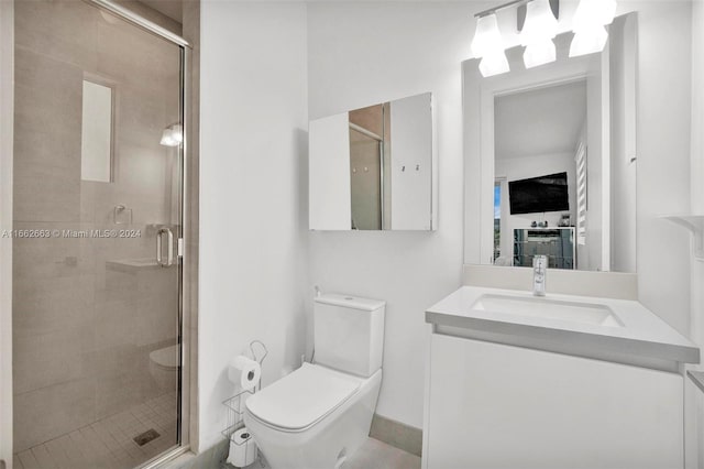 bathroom with vanity, toilet, and a shower with shower door