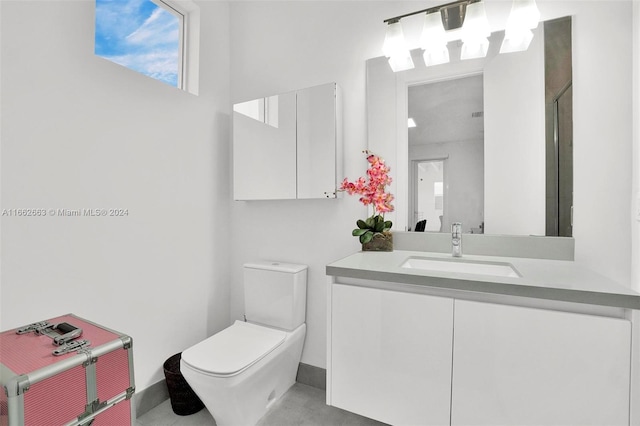 bathroom with a shower, vanity, and toilet