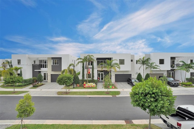 view of front of home with a balcony and a garage