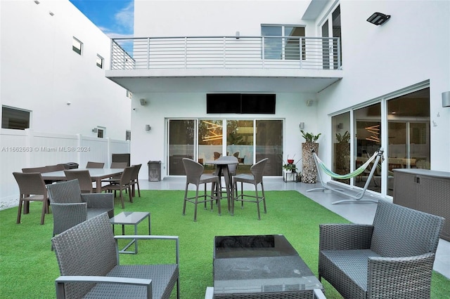 exterior space with a patio, a balcony, and a yard