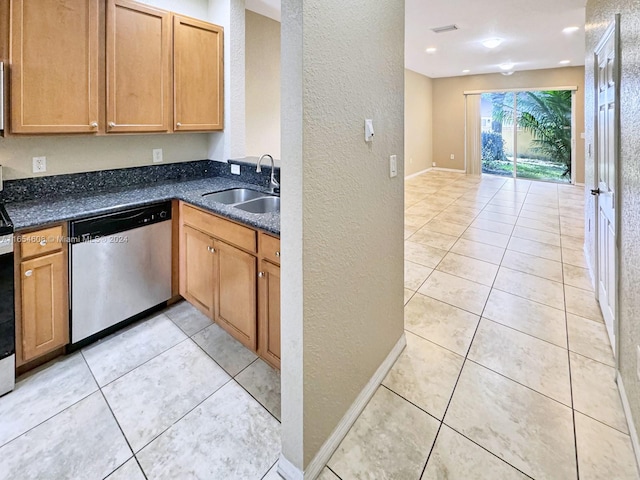 kitchen with light tile patterned floors, sink, and stainless steel dishwasher