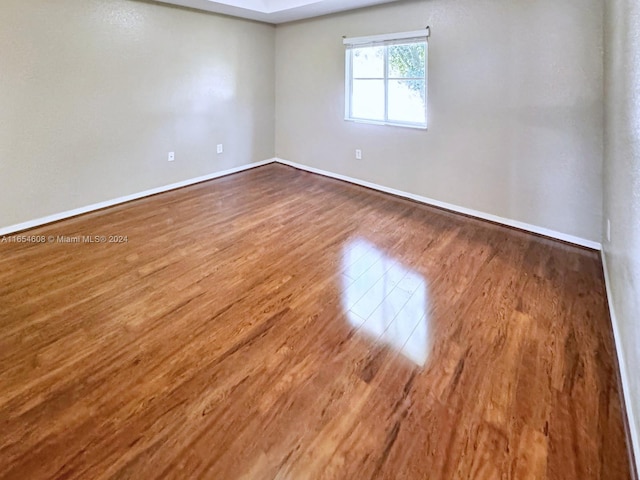 unfurnished room with hardwood / wood-style floors