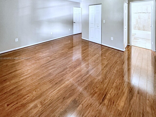 interior space featuring ensuite bathroom and hardwood / wood-style floors