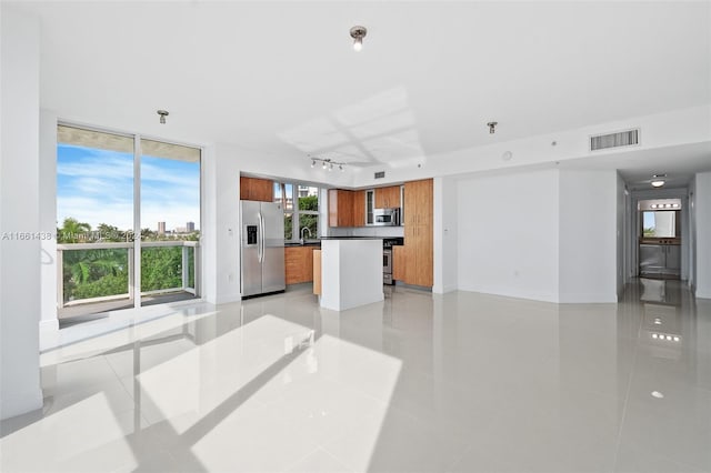 living room with light tile patterned floors and sink