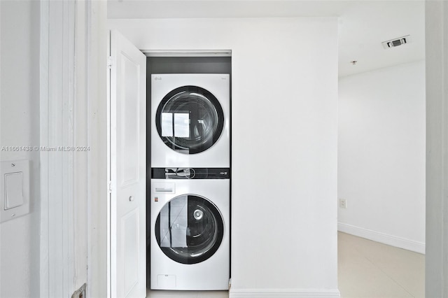 laundry room with stacked washer and dryer