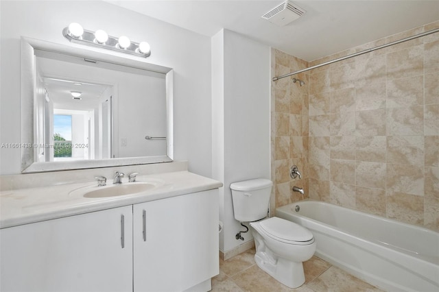 full bathroom featuring tile patterned flooring, vanity, toilet, and tiled shower / bath