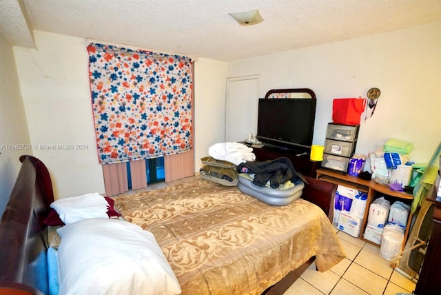 tiled bedroom with a textured ceiling